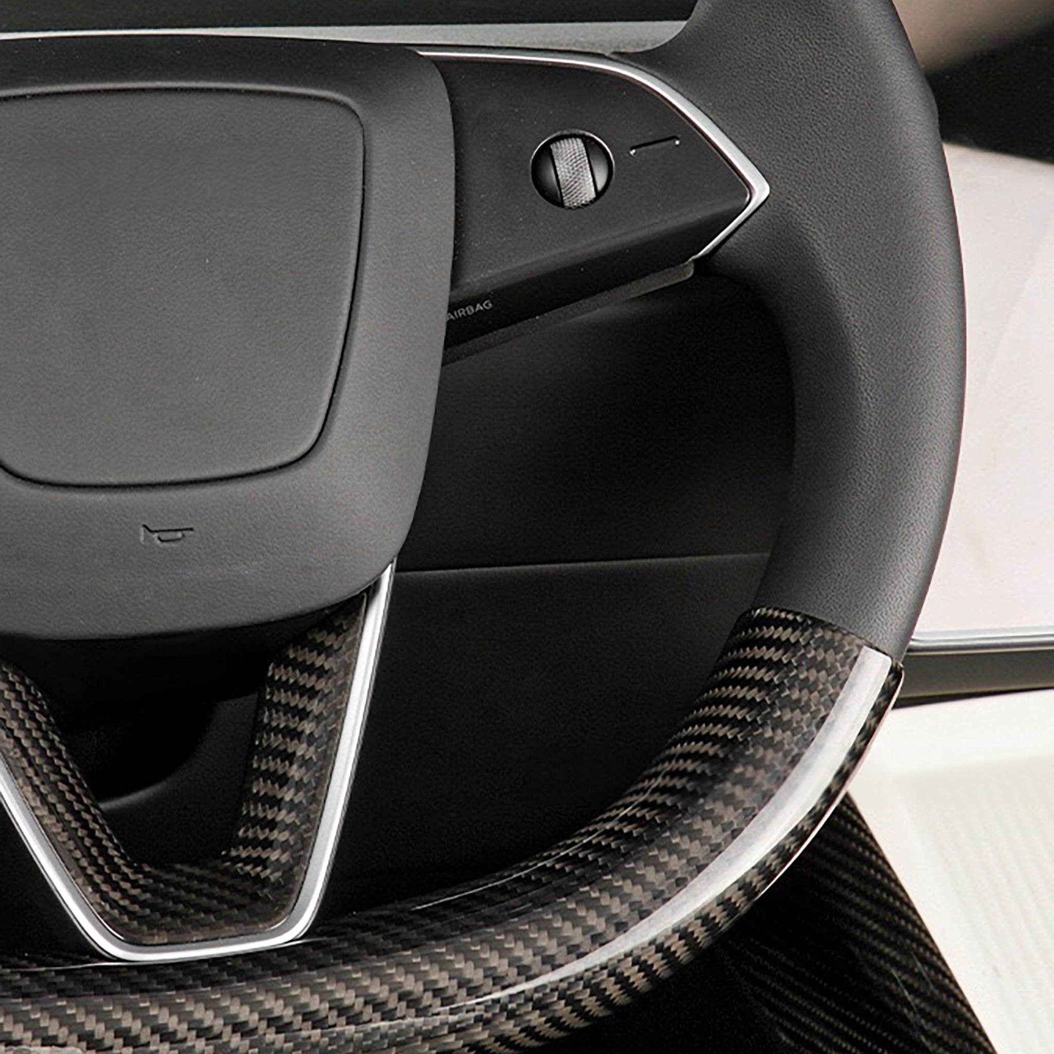 Close-up view of real carbon fiber texture on Tesla Model Y Juniper steering wheel overlay