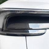 Detailed shot of glossy carbon fiber finish on Tesla Model Y Juniper taillight overlay