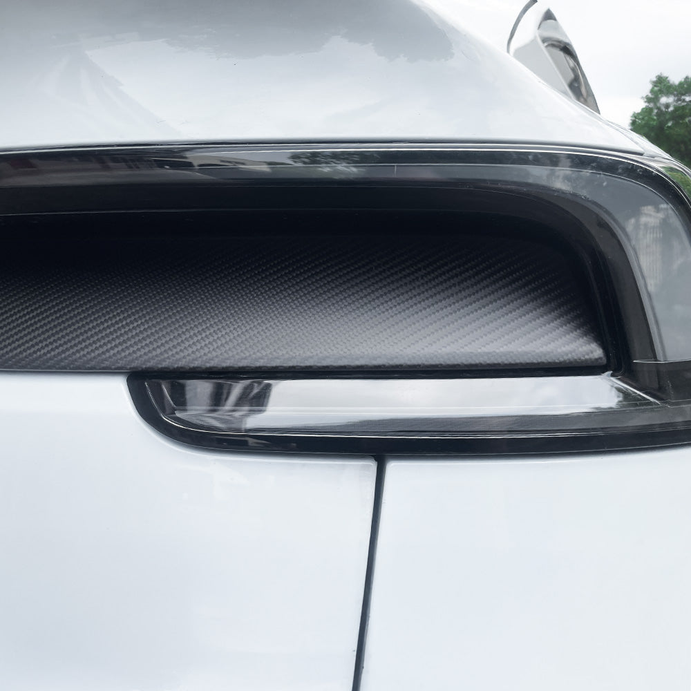 Detailed shot of matte carbon fiber finish on Tesla Model Y Juniper taillight overlay