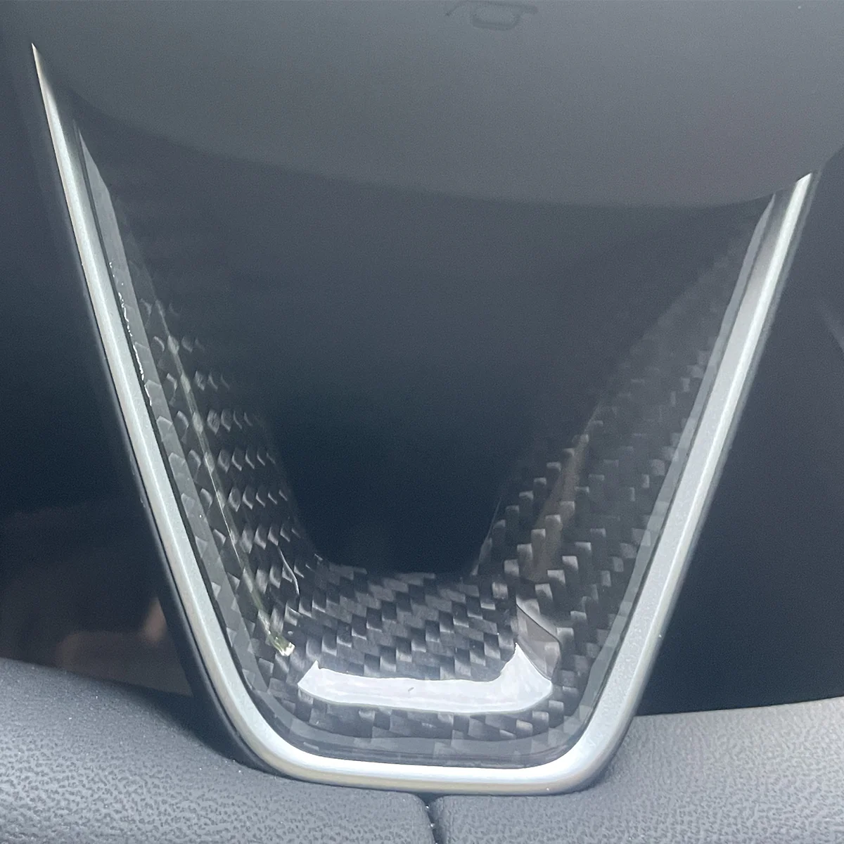Glossy finish carbon fiber texture on Model Y Juniper steering wheel trim