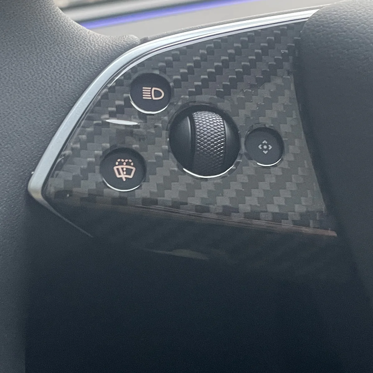 Glossy finish carbon fiber texture on Model Y Juniper steering wheel trim