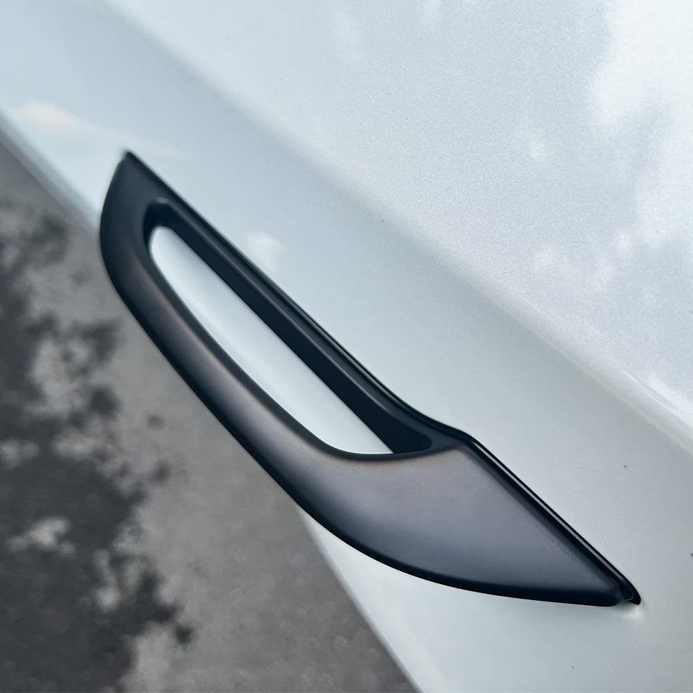 A view showing the door handle add-on installed on a white Tesla Model Y.