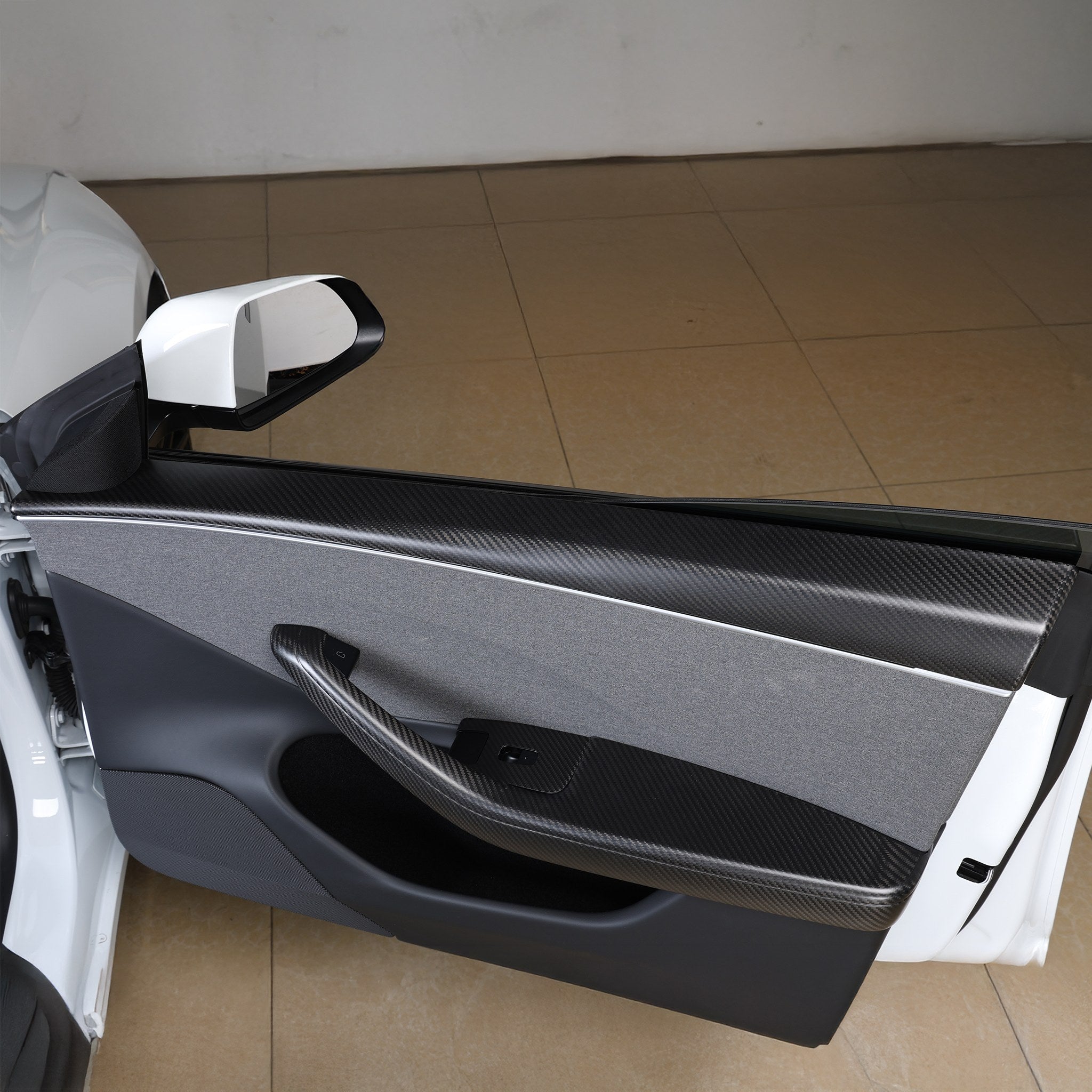 Real Carbon Fiber Front Armrest Cover installed on 2024+ Model 3 Highland