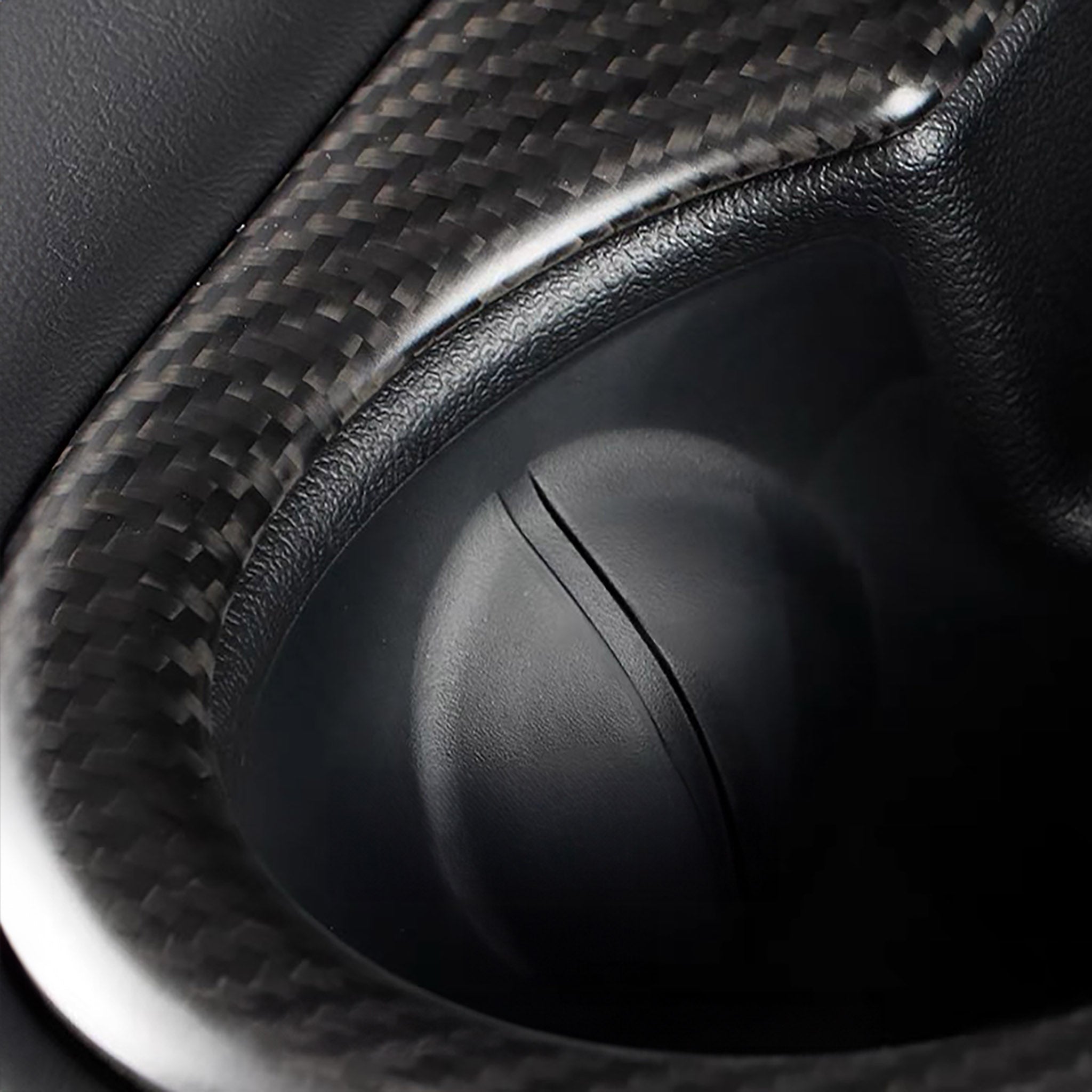 close up of Tesla Model Y Juniper Real Carbon Fiber Rear Cup Holder Cover