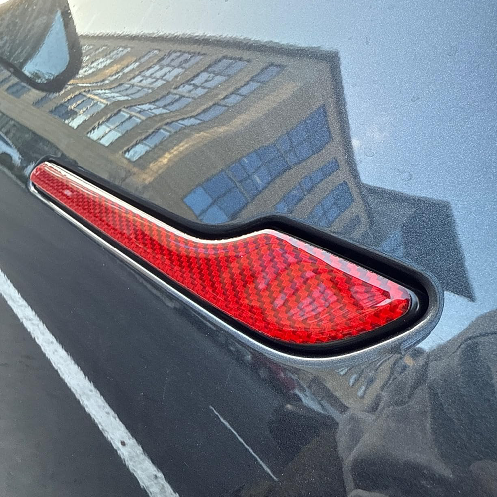 Tesla Model Y with red carbon fiber door handle cover installed