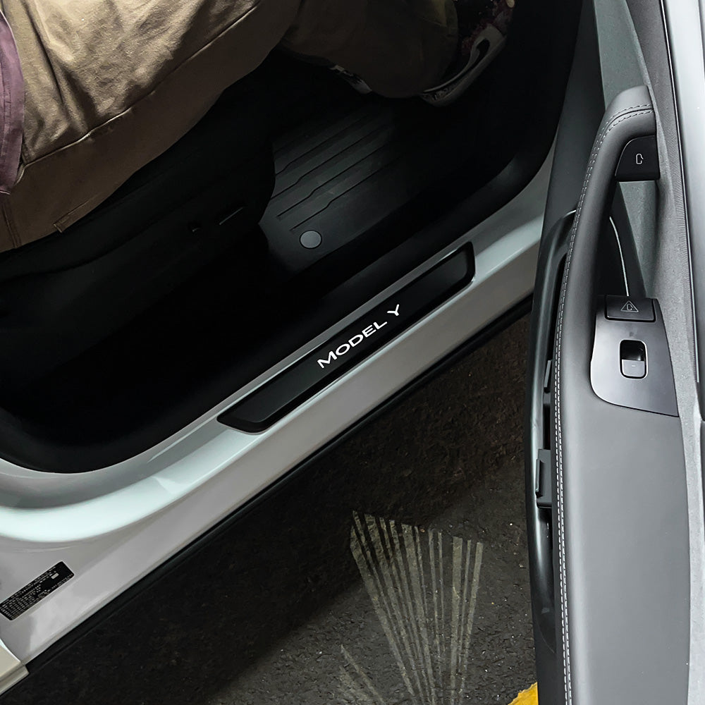 LED illuminated Welcome Pedal Door Sill Protector installed on Tesla Model Y