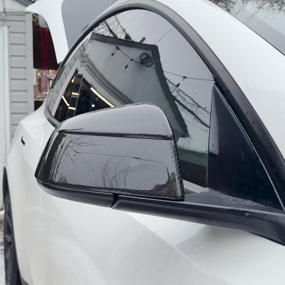 Side view of Tesla model Y Juniper with Carbon Fiber Mirror Caps installed - glossy finish