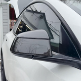 Side view of Tesla model Y Juniper with Carbon Fiber Mirror Caps installed - glossy finish