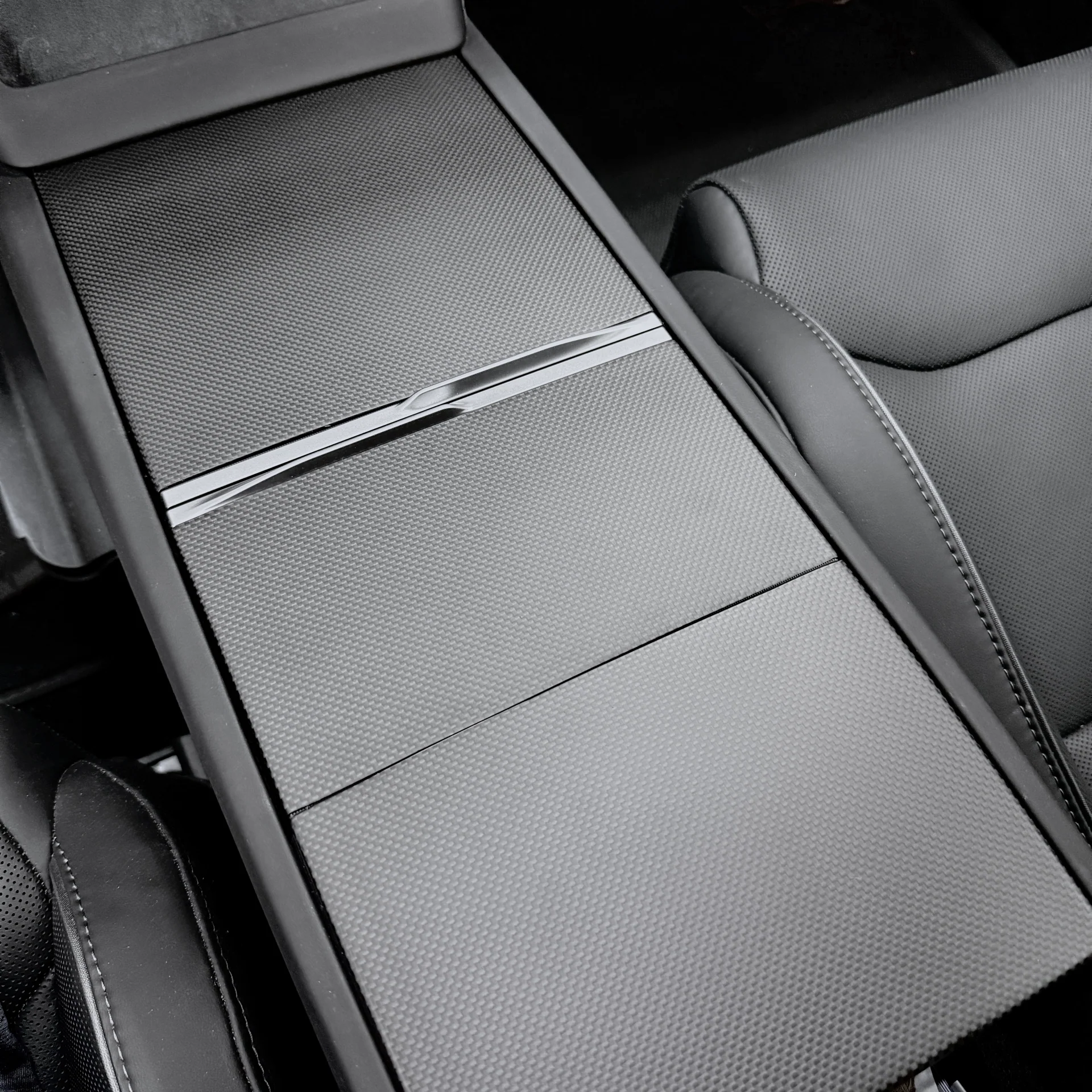 Real carbon fiber Console overlays installed on Tesla Model Y - detail shot