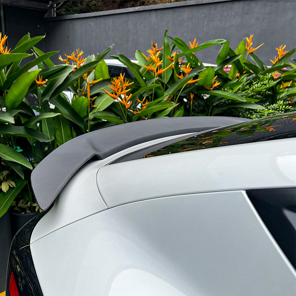 Side view of Tesla Model Y Juniper with RT-style carbon fiber spoiler installed