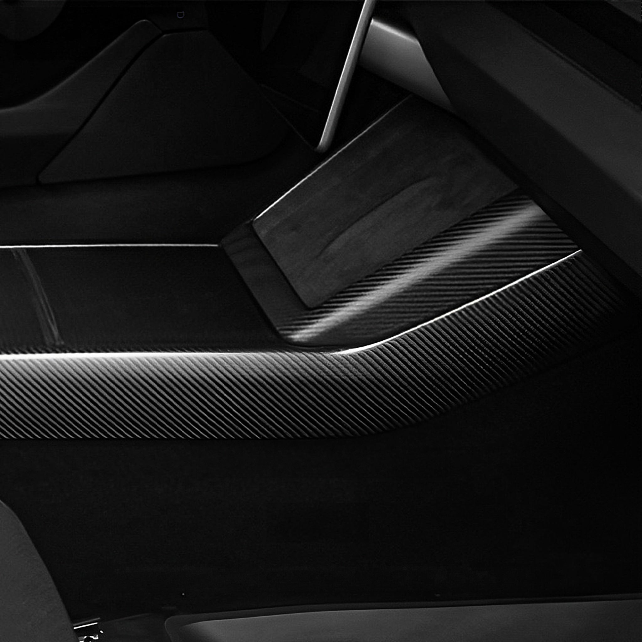Close-up view of real carbon fiber texture on Tesla Model 3 Highland console side panel cover
