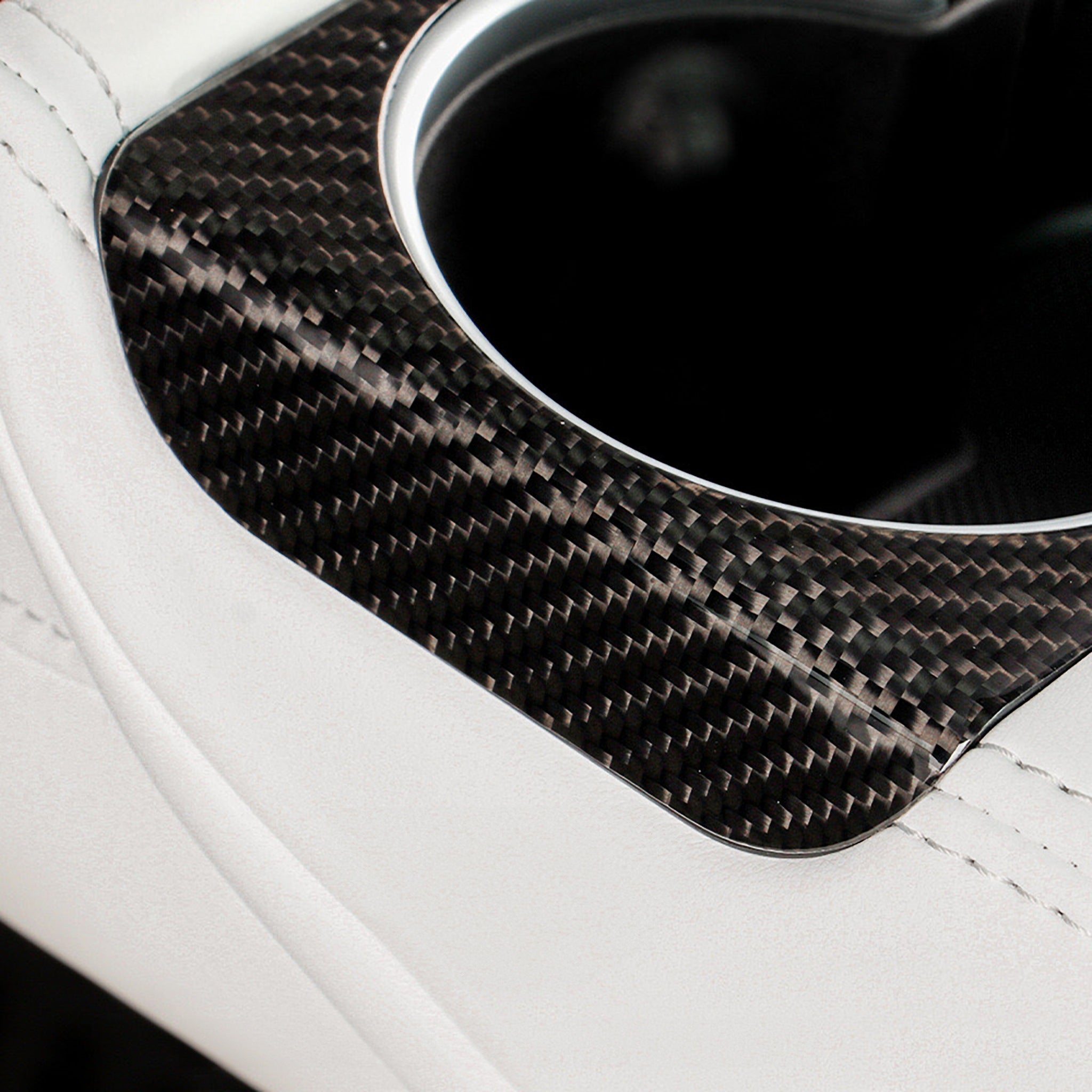 Close-up of Carbon Fiber rear Cup Holder Cover installed on Tesla Model 3 Highland