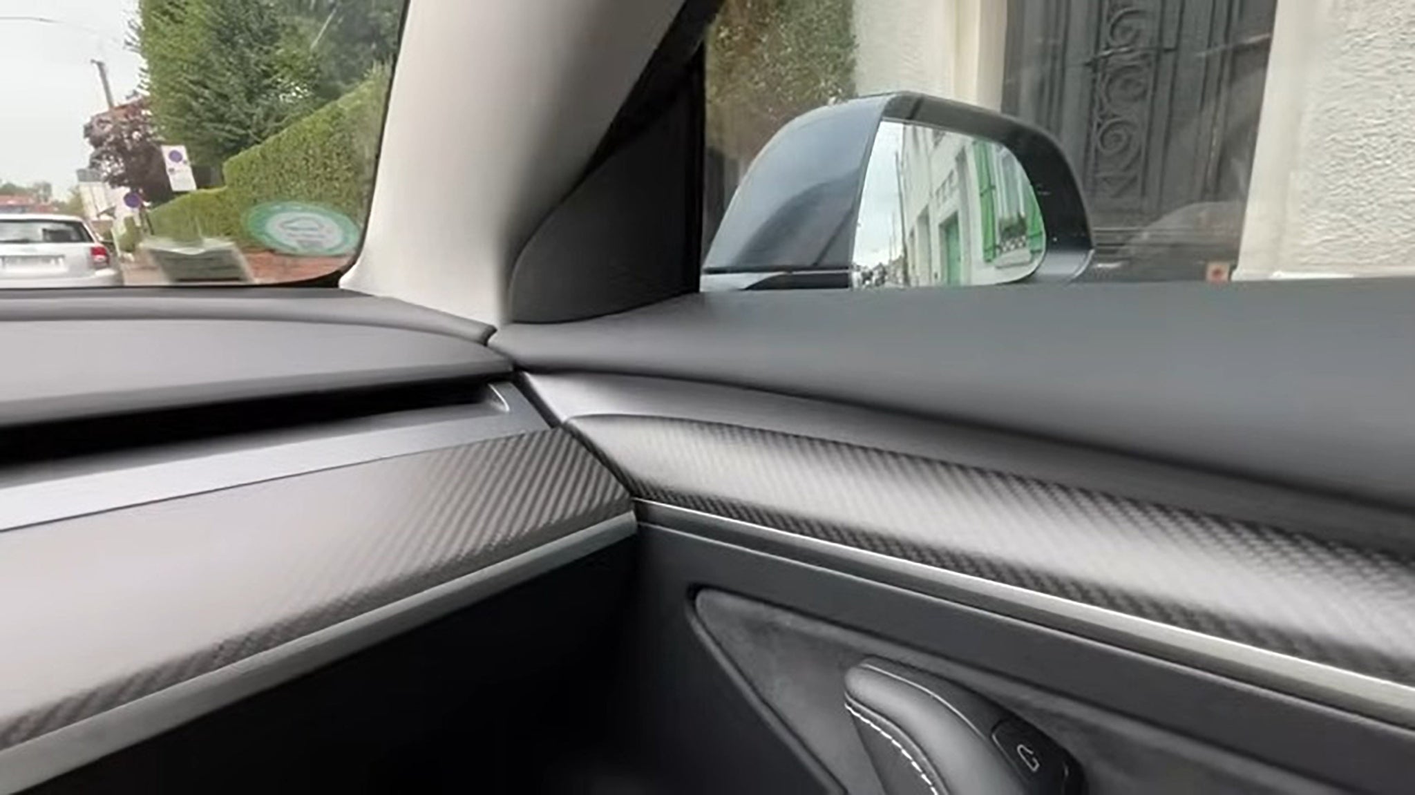 Close up of Real Carbon Fiber Front Door Trim Cover and dashboard cover installed on Tesla model 3/Y