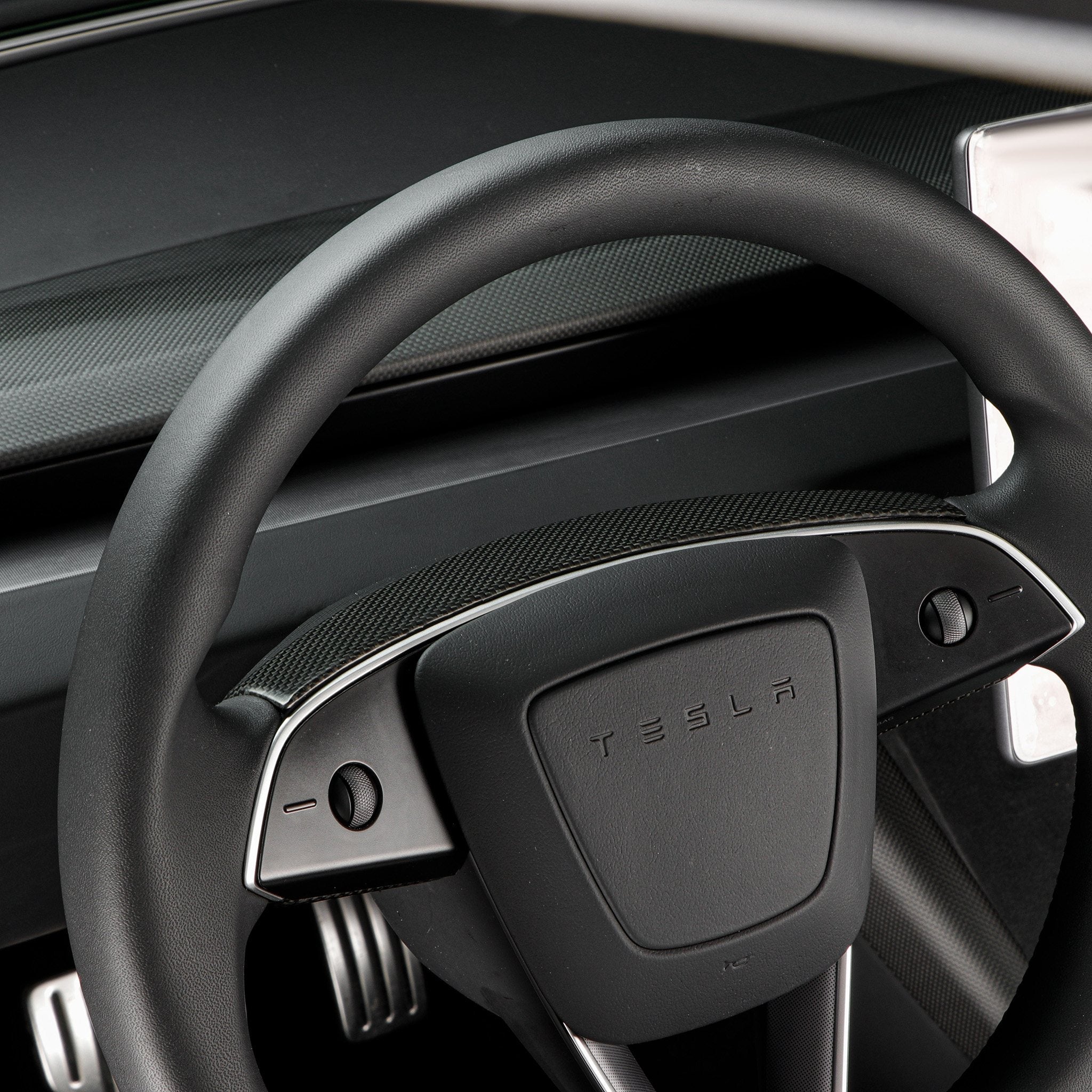 Tesla model Y with real carbon fiber steering wheel trim cover installed
