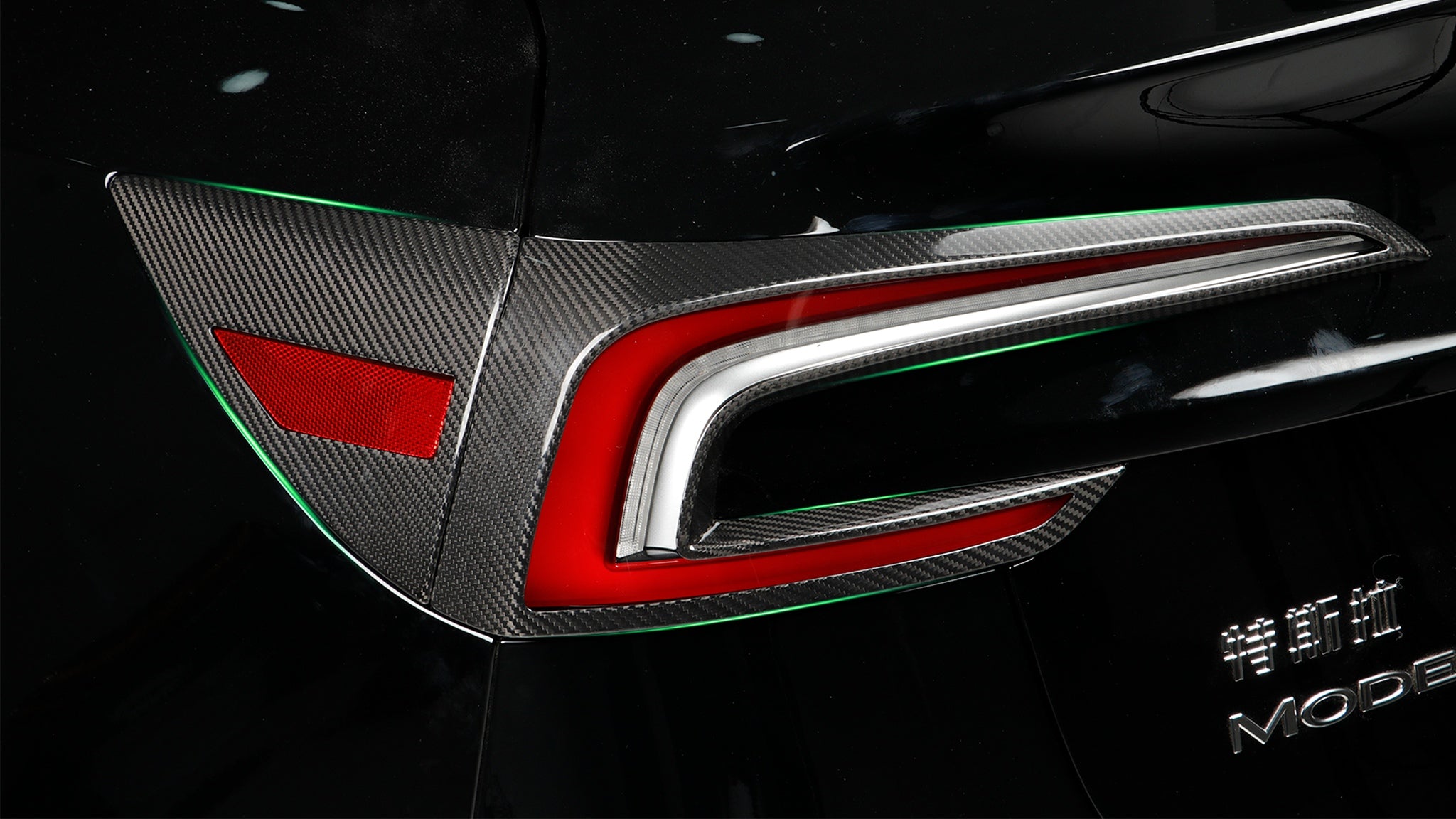 side view of Tesla with installed Carbon Fiber charging port panel & Tail Light accent