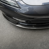 Close-up of Real Carbon Fiber Aero Front Lip Spoiler installed on 2024+ Tesla Model 3 Premium