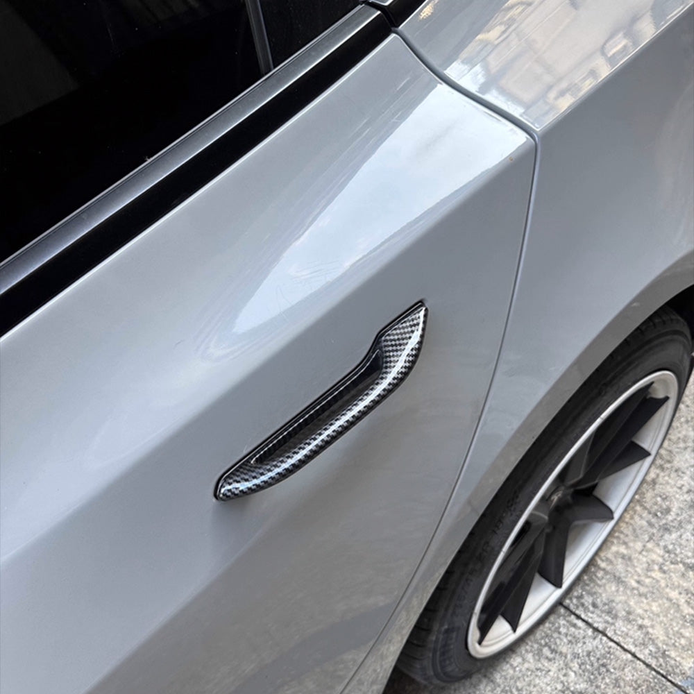 A view of carbon fiber textured door handle add-on parts installed on a Tesla Model Y