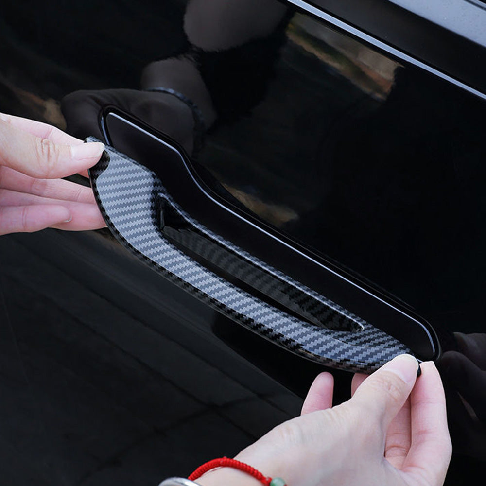 The Tesla door handle attachment is being glued onto the door handle.