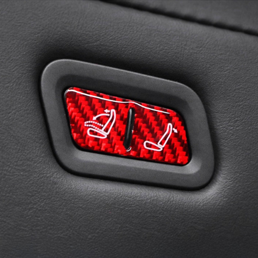Close-up view of Carbon Fiber Rear Seat Folding Button Trim installed on Tesla Model Y Juniper