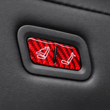 Close-up view of Carbon Fiber Rear Seat Folding Button Trim installed on Tesla Model Y Juniper