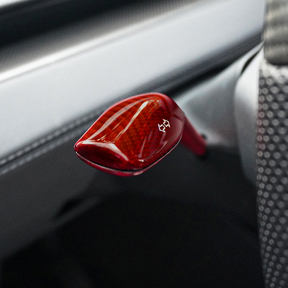 Close-up view of red glossy Carbon Fiber Turn Signal Stalk Covers intalled on Tesla Model Y Juniper