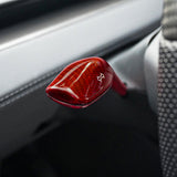 Close-up view of red glossy Carbon Fiber Turn Signal Stalk Covers intalled on Tesla Model Y Juniper