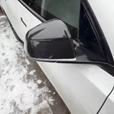 close-up detail shot of Tesla model Y Juniper with Carbon Fiber Mirror Caps installed - glossy finish