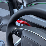 side view of Red glossy Carbon Fiber Turn Signal Stalk Covers installed on Tesla Model Y Juniper