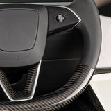 Close-up view of real carbon fiber texture on Tesla Model Y Juniper steering wheel overlay