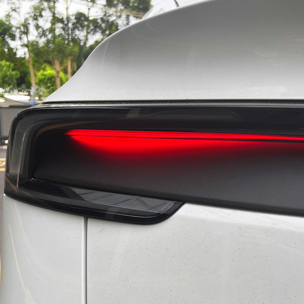 Detailed shot of matte carbon fiber finish on Tesla Model Y Juniper taillight overlay