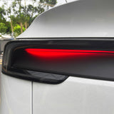 Detailed shot of matte carbon fiber finish on Tesla Model Y Juniper taillight overlay