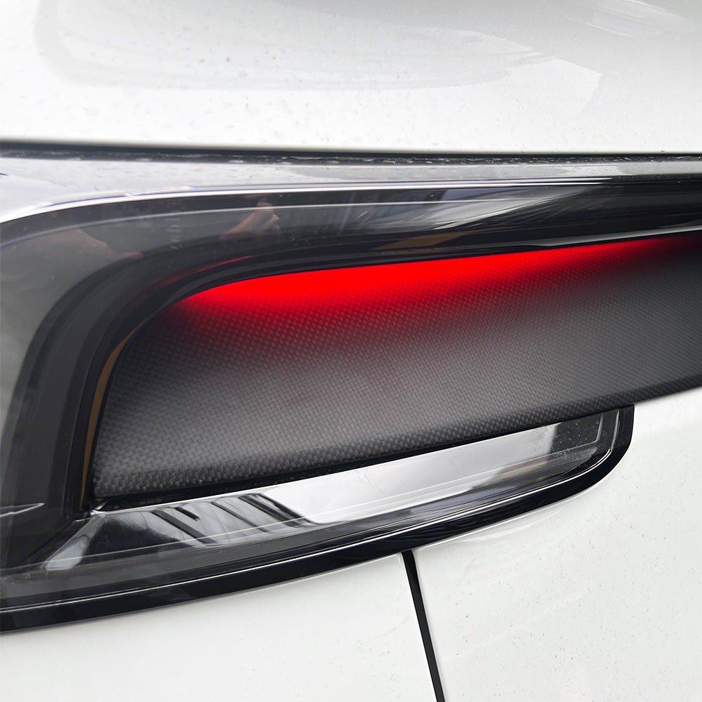 Detailed shot of matte carbon fiber finish on Tesla Model Y Juniper taillight overlay