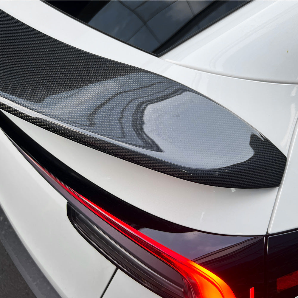close-up detail shot of model Y Juniper V-style carbon fiber spoiler