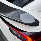 close-up detail shot of model Y Juniper V-style carbon fiber spoiler