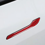 White Tesla Model Y with red carbon fiber door handle cover installed