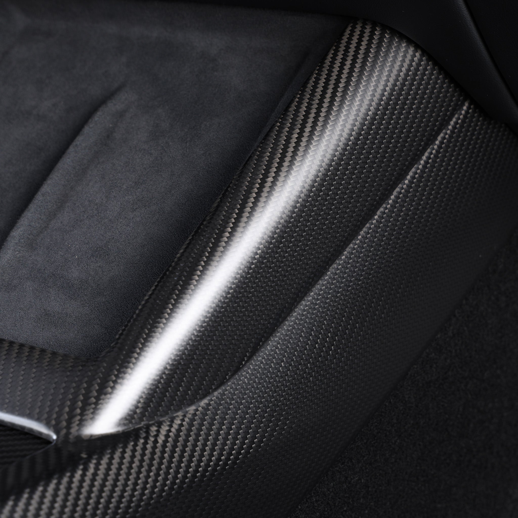 Close-up view of the carbon fiber texture on Center Console Side Trim Cover for 2024+ Tesla Model 3 Highland