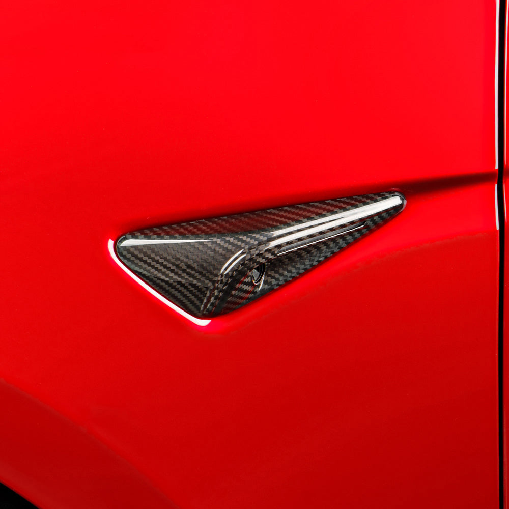 Side view of Real Carbon Fiber Side Camera Covers installed on Red Tesla Model 3