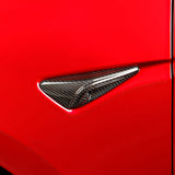 Side view of Real Carbon Fiber Side Camera Covers installed on Red Tesla Model 3