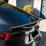 Side view of Carbon Fiber Spoiler installed on black Tesla Model 3 Highland